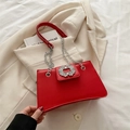 Elegant red leather handbag with sparkling rhinestone buckle and silver chain strap - Red
