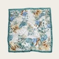 Square floral silk scarf with blue-purple flowers and blue-green border in flat lay - 90cmx90cm / Blue With Leaves