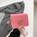 Chic pink textured square crossbody bag featuring a silver metal M logo and leather strap - Pink