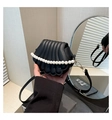 Detail of shell-shaped black leather handbag with large pearl handle and gold hardware - Black