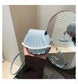 Detail of light blue shell crossbody bag featuring pearl chain trim and high-quality leather - Blue