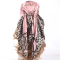 Pink satin square scarf featuring leopard print and gold chain patterns on a mannequin head - Pink
