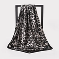 Classic leopard print satin square scarf in black and grey hanging on a metal rack - BX151 Black Leopard