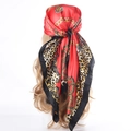 Red leopard chain print satin scarf shown as a hair wrap on blonde wavy hair - Red