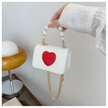 Detail of mini ivory crossbody bag with red heart patch and pearl bead handle - White