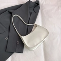 Minimalist white baguette underarm bag in faux leather with gold-tone hardware rings - White