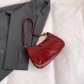 Deep red patent leather baguette bag with high-gloss finish and gold hardware - Red