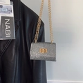 Mini silver sequin flap bag with gold chain and metal lock on a black leather jacket - Silver