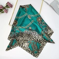Green leopard and chain print silk feeling square scarf shown with luxury props - Turquoise Green