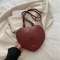 Dark red heart-shaped crossbody bag with crocodile pattern and gold lettering details - Red