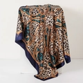 Leopard and chain print satin silk scarf in navy and brown on a white pedestal - Blue Palace Leopard (Style 6)
