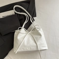 Chic white leather shoulder bag featuring a large decorative bow and soft minimalist style - White