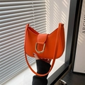 Bright orange crescent hobo shoulder bag with a gold horseshoe buckle and smooth finish - Orange