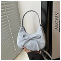 Detail of light blue crescent bag featuring a bow tie and pleated texture leather - Blue