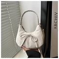 Detail of white half-moon bag featuring a large bow and soft textured fabric finish - White