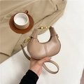 Beige crescent dumpling bag with golden hardware and adjustable crossbody strap - Khaki