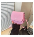 Close-up of pink textured fabric saddle bag featuring white Fashion Trend lettering - Pink