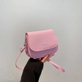 Pink saddle crossbody bag with textured woven pattern and adjustable shoulder strap - Pink