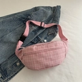 Pink tweed crossbody belt bag with adjustable strap over a blue denim jacket - Pink