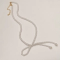 Close-up of pearl necklace featuring a knotted bow design with golden clasp detail - Bright Pearl Bow Necklace