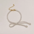 Elegant pearl bracelet with gold hardware arranged in a creative bow shape - Premium Pearl Bowknot Bracelet