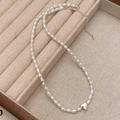 Detail of pearl heart necklace with silver pendant in a beige velvet jewelry box - Silver Heart Pendant High Luster Pearl Chain