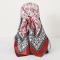 Close-up of red and white paisley silk-like satin headscarf tied at the back - 90x90cm / Burgundy Splicing