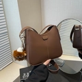 Deep brown leather bucket bag with large capacity and plush charm for spring 2025 - With Pendant / Brown