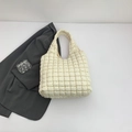Minimalist beige quilted tote bag with soft padded texture and urban chic style - White