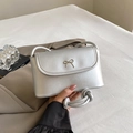 Silver square shoulder bag with a metallic bow and knotted rope handle design - Matte Silver