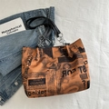 Fashionable newspaper print tote bag with brown finish and metal chain strap - Orange