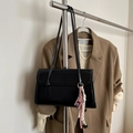 Minimalist black leather tote bag with decorative woven pendant and slim shoulder straps - No Pendant / Black