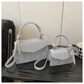 Detail of light blue wrinkled leather bag showing knotted handle and gold hardware - Large / Blue