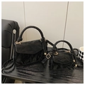 Detail of two black wrinkled leather tote bags with gold hardware and knot handles - Large / Black