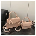 Close-up of pink marble pattern handbag set with knotted handle on wooden surface - Large / Pink