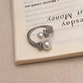 Detailed view of adjustable pearl and zircon ring placed on a vintage book page - Silver Pearl Open Ring