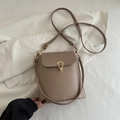 Minimalist light brown leather crossbody bag with elegant gold U-shaped metal buckle - Khaki