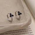 Macro shot of silver clover hoop earrings with black stones and micro-pave white zircons - Silver Black Flower