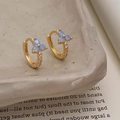 Macro shot of gold earrings with blue opal-like stones and white zircon accents - Gold With Blue Flower (Synthetic Opal)
