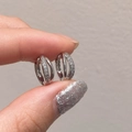 Close-up of geometric silver hoop earrings with triple rows of micro-pave zircons - Silver