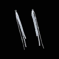 Close-up of sparkling silver tassel earrings with micro-pave crystals on black background - Pull-through Tassel Earrings / Silver