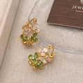Macro detail of gold flower hoop earrings with green enamel petals and inlaid zircon - Green Flower Ear Buckle / Green Gold