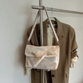 Minimalist cream patent leather crossbody bag with gold buckle on a stylish suit background - White With Pendant