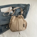 Minimalist light khaki drawstring bucket bag with adjustable strap and mesh side pocket - Khaki