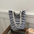Minimalist navy striped canvas tote bag with thick shoulder straps on a wooden table - Blue and White Horizontal Stripes / Blue