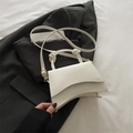 Minimalist white crossbody bag with curved base and elegant knotted handle design - White