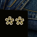 Close-up of olive green zircon flower earrings with gold plating on denim background - Petal Stud Earrings / Olive Green Zirconia