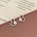 Dettaglio degli orecchini a forma di zucca con micro-zirconi e perla bianca elegante - Argento