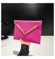 Macro view of rose red envelope clutch featuring V-shaped quilting and gold metal trim - Rose Red