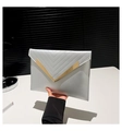 Detail of silver envelope clutch bag with V-quilted texture and gold metal clasp - Silver